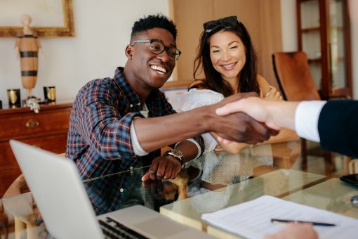 Couple shaking hands in a meeting